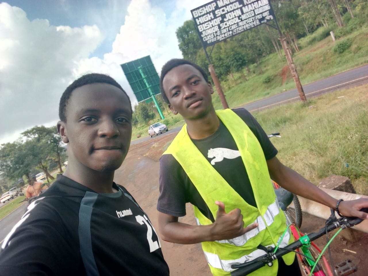 Two cyclists posing for a picture